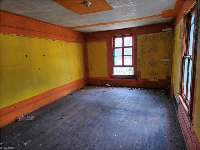 empty room featuring dark wood-type flooring and a textured ceiling