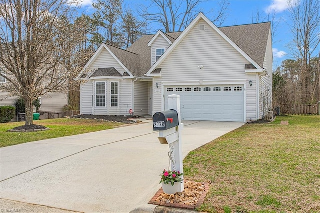 traditional-style home with a front yard, fence, a shingled roof, concrete driveway, and a garage