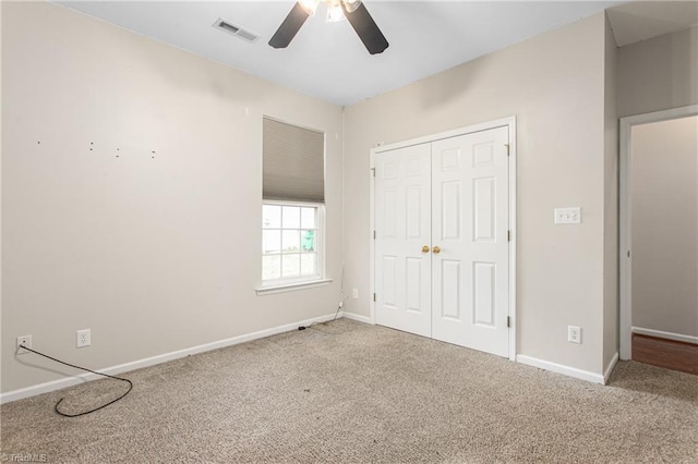 unfurnished bedroom featuring carpet flooring, baseboards, visible vents, and a closet