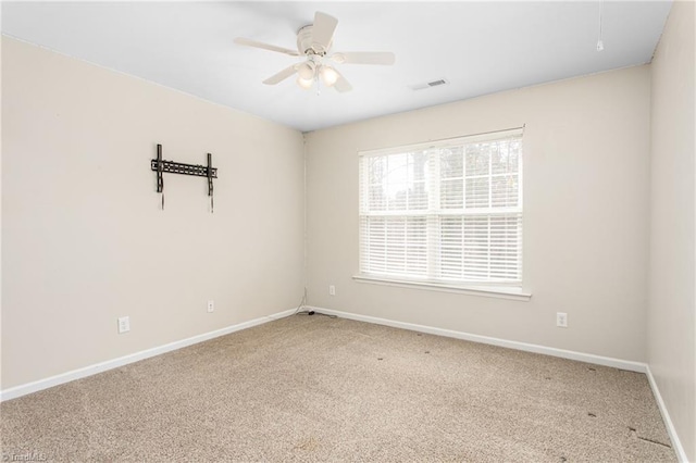 unfurnished room with a ceiling fan, carpet flooring, baseboards, and visible vents