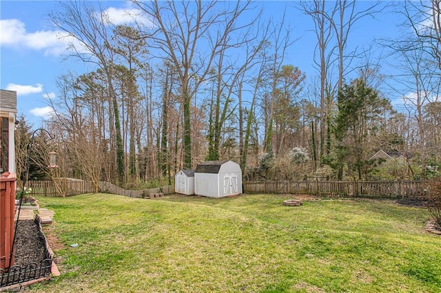 view of yard with a fenced backyard, a storage shed, and an outdoor structure