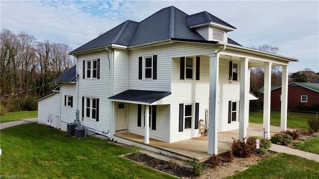 view of front of property featuring covered porch, central AC unit, and a front lawn