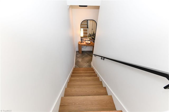 stairway featuring baseboards