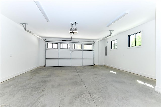 garage with baseboards and a garage door opener