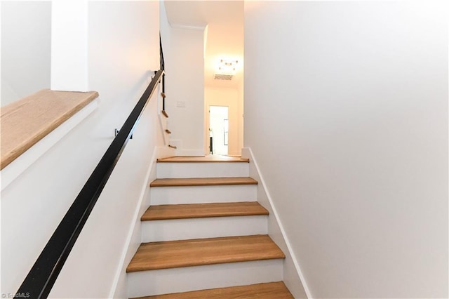 stairway featuring visible vents