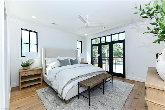 bedroom featuring visible vents, ornamental molding, light wood-style floors, and access to exterior