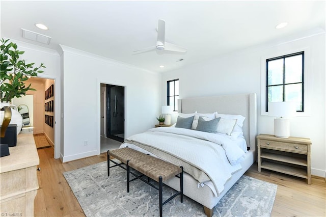 bedroom with crown molding, recessed lighting, visible vents, and light wood-style flooring