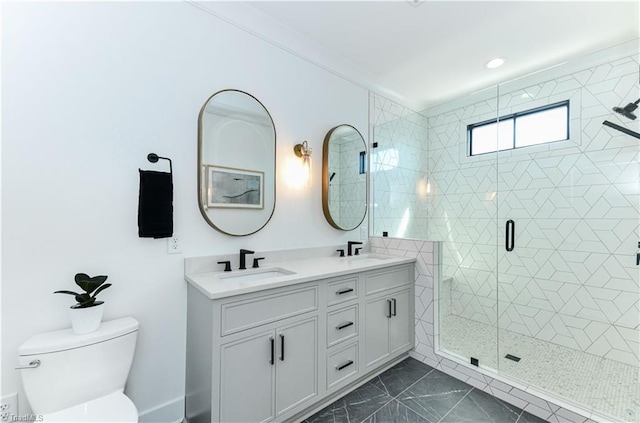 full bath featuring double vanity, toilet, a shower stall, and a sink