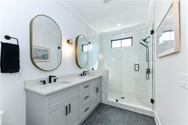 bathroom featuring double vanity, recessed lighting, a shower stall, and a sink