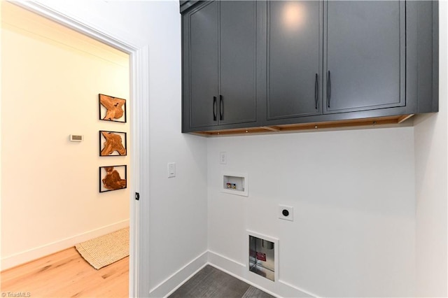 laundry area featuring wood finished floors, baseboards, hookup for a washing machine, cabinet space, and hookup for an electric dryer