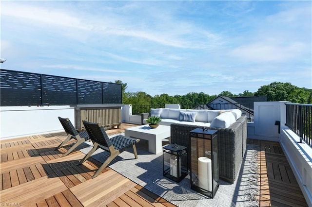 wooden terrace with an outdoor living space