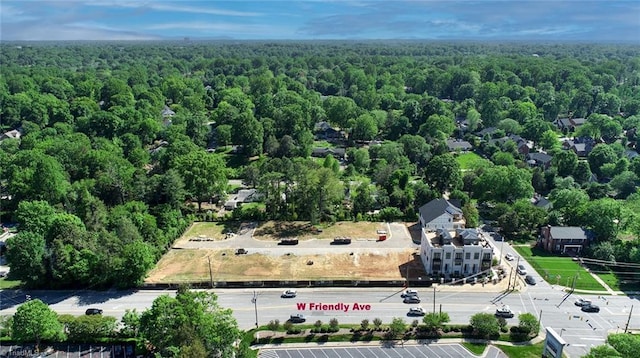 bird's eye view with a wooded view