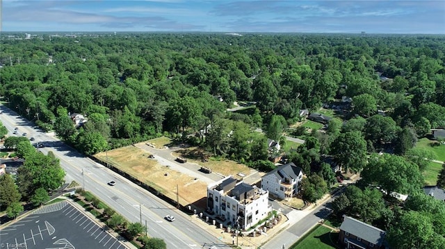 birds eye view of property featuring a view of trees