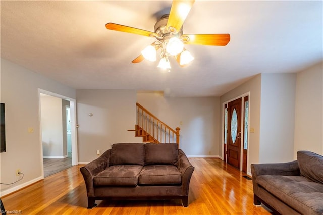 living room featuring ceiling fan and light hardwood / wood-style floors