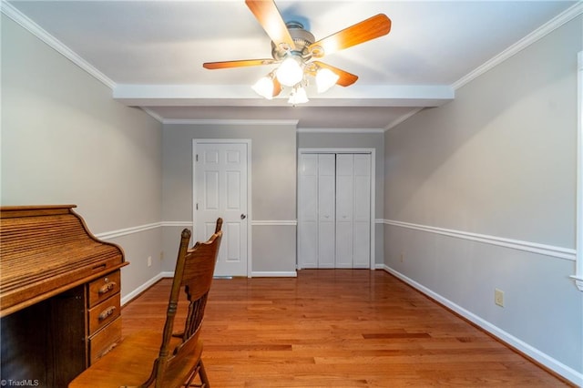 office area with light wood-type flooring, ceiling fan, and crown molding