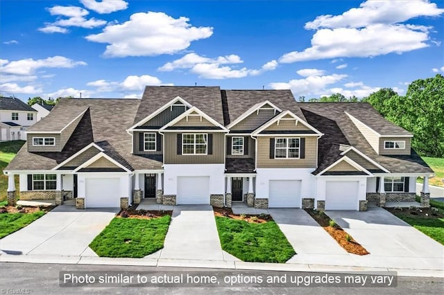 multi unit property featuring board and batten siding, driveway, and stone siding