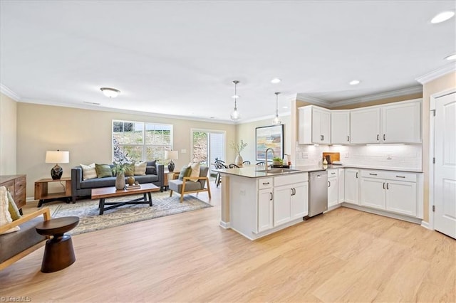 kitchen with stainless steel dishwasher, a peninsula, and crown molding