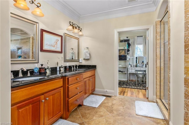 bathroom featuring wood-type flooring, vanity, a shower with door, and ornamental molding