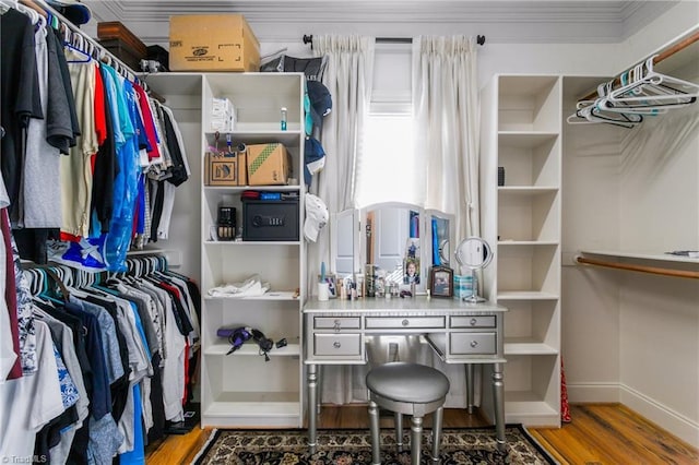 walk in closet with hardwood / wood-style flooring