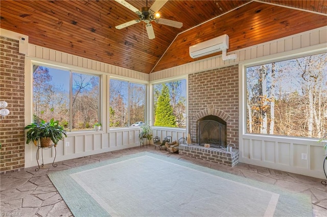 unfurnished sunroom featuring an outdoor brick fireplace, vaulted ceiling, a wall mounted AC, ceiling fan, and wooden ceiling