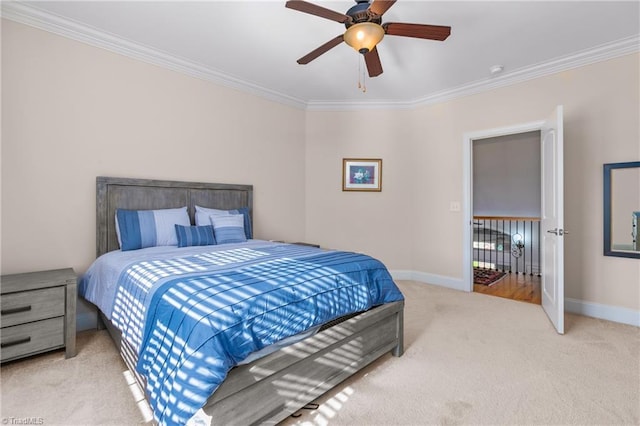 carpeted bedroom featuring ceiling fan and ornamental molding