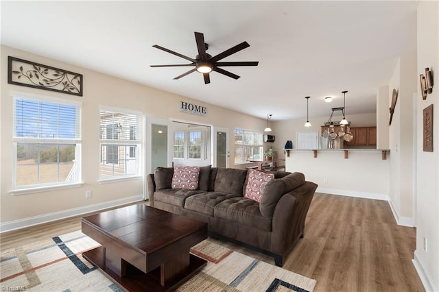 living room with ceiling fan and light hardwood / wood-style floors