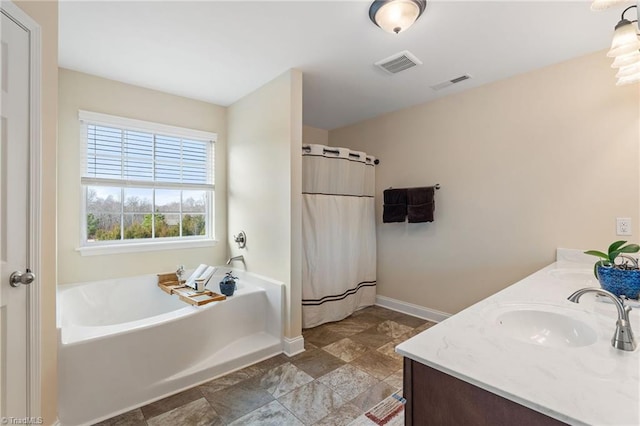 bathroom with vanity and separate shower and tub