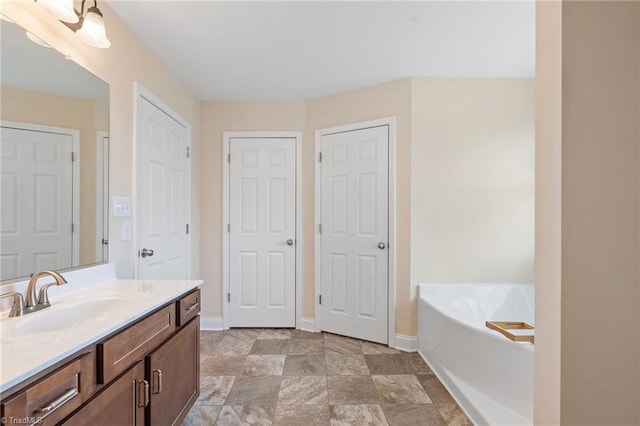 bathroom featuring vanity and a bath