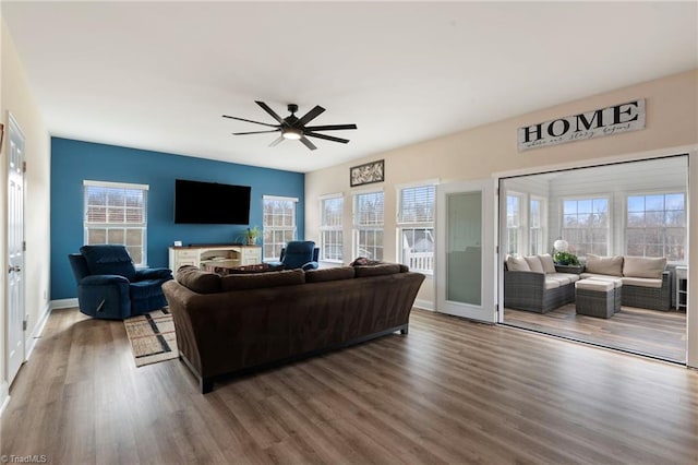 living room with ceiling fan and hardwood / wood-style floors