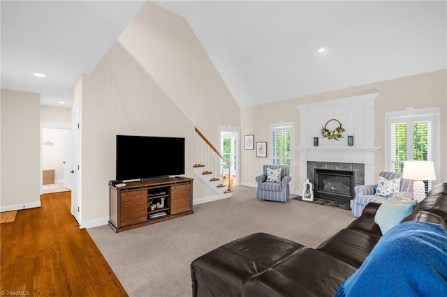 153 Montauk Ct, Clemmons, NC 27012 - living area featuring stairs, plenty of natural light, a tiled fireplace, high vaulted ceiling, and recessed lighting