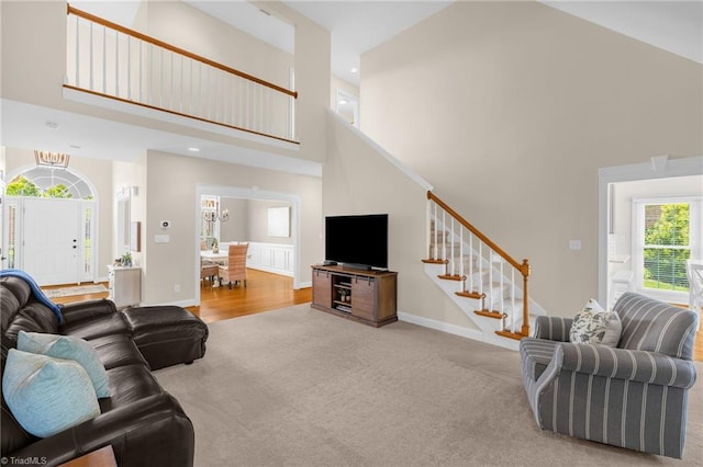 153 Montauk Ct, Clemmons, NC 27012 - living area featuring high vaulted ceiling, carpet floors, stairs, recessed lighting, and wood finished floors