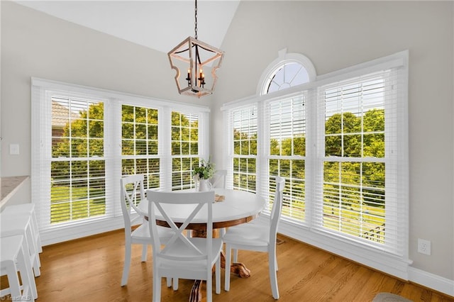 153 Montauk Ct, Clemmons, NC 27012 - dining area featuring a chandelier, healthy amount of natural light, high vaulted ceiling, and light wood finished floors