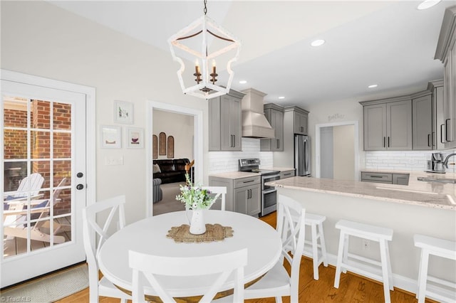 153 Montauk Ct, Clemmons, NC 27012 - dining space with light wood-style floors, a chandelier, and recessed lighting