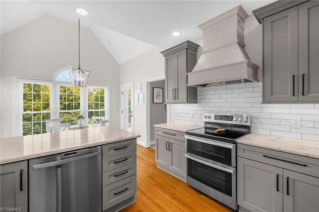 153 Montauk Ct, Clemmons, NC 27012 - kitchen with stainless steel appliances, premium range hood, gray cabinets, a chandelier, and backsplash