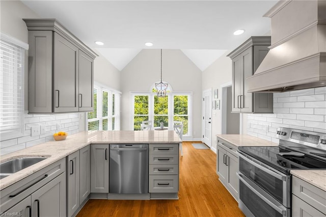 153 Montauk Ct, Clemmons, NC 27012 - kitchen with appliances with stainless steel finishes, custom exhaust hood, gray cabinetry, a peninsula, and lofted ceiling