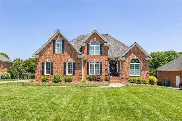 153 Montauk Ct, Clemmons, NC 27012 - traditional home with brick siding and a front lawn