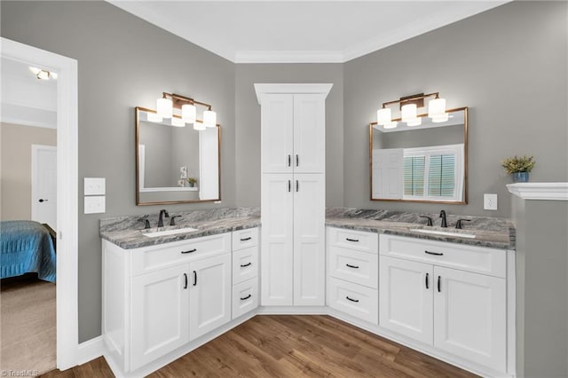 153 Montauk Ct, Clemmons, NC 27012 - full bath featuring wood finished floors, two vanities, ensuite bath, and ornamental molding
