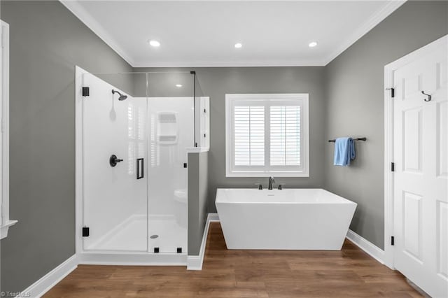 153 Montauk Ct, Clemmons, NC 27012 - full bathroom with ornamental molding, a stall shower, a freestanding bath, wood finished floors, and recessed lighting