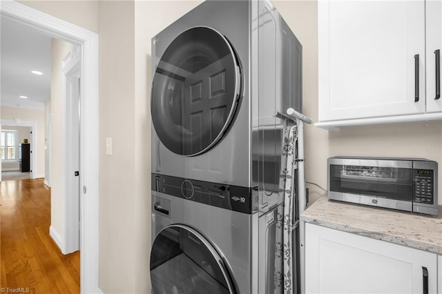 153 Montauk Ct, Clemmons, NC 27012 - washroom with stacked washer / dryer, light wood-style flooring, and recessed lighting