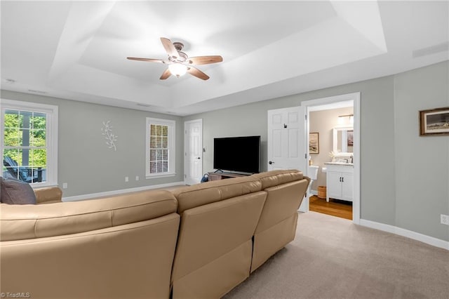 153 Montauk Ct, Clemmons, NC 27012 - living room featuring a tray ceiling, ceiling fan, and light colored carpet