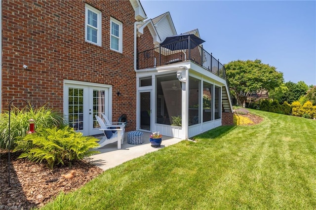 153 Montauk Ct, Clemmons, NC 27012 - back of house with a balcony, brick siding, french doors, and a yard