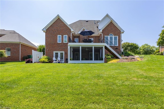 153 Montauk Ct, Clemmons, NC 27012 - rear view of property featuring a sunroom, brick siding, a lawn, and stairway