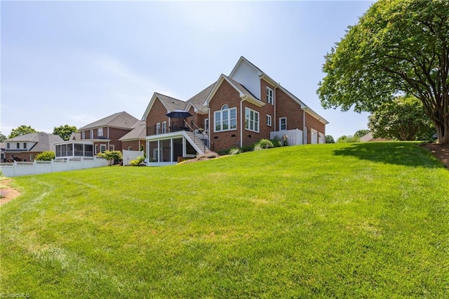 153 Montauk Ct, Clemmons, NC 27012 - back of house featuring a sunroom, brick siding, stairway, and a garage