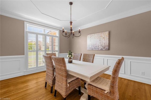 153 Montauk Ct, Clemmons, NC 27012 - dining area with a chandelier, a wainscoted wall, light wood-type flooring, ornamental molding, and a decorative wall
