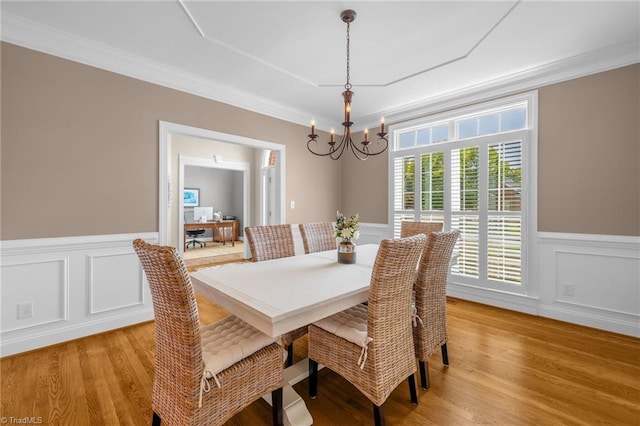 153 Montauk Ct, Clemmons, NC 27012 - dining area with a chandelier, light wood-style floors, a wainscoted wall, ornamental molding, and a decorative wall