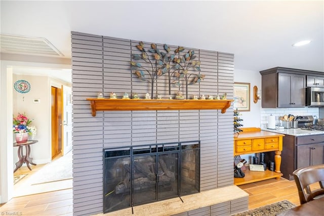 144 Collins Rd, Sparta, NC 28675 - interior space with decorative backsplash, appliances with stainless steel finishes, and a brick fireplace