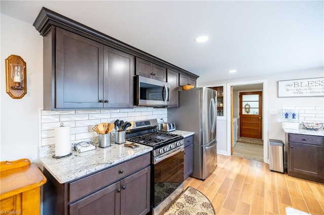 144 Collins Rd, Sparta, NC 28675 - kitchen featuring dark brown cabinets, stainless steel appliances, light stone counters, and tasteful backsplash
