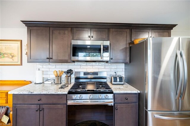144 Collins Rd, Sparta, NC 28675 - kitchen featuring light stone counters, dark brown cabinetry, and stainless steel appliances