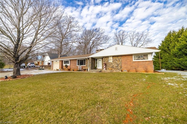 ranch-style home with a garage and a front yard