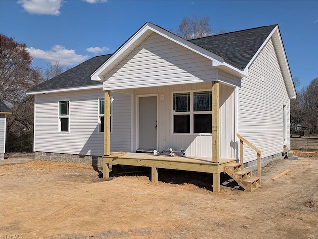 view of front of property featuring crawl space and a shingled roof